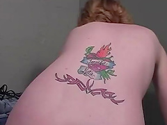 Skinny and tattooed babe sucks a big black dick through a glory hole