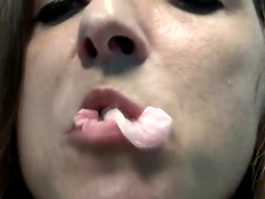 Brunette babe in sexy nurses' uniform and nylon stocking popping gum