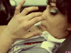 Lecherous lesbian pornstar fingering her pussy as she fondles her tits in a car