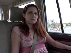 Seductive solo model with long hair masturbating in the car in a close up shoot