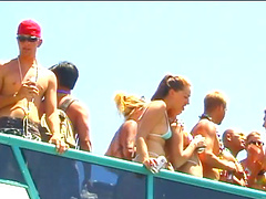 Blondes wearing bikinis flashing their nice asses in an outdoors beach party