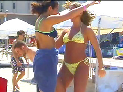 Blondes wearing bikinis flashing their nice asses in an outdoors beach party