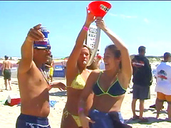 Blondes wearing bikinis flashing their nice asses in an outdoors beach party