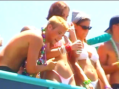 Blondes wearing bikinis flashing their nice asses in an outdoors beach party