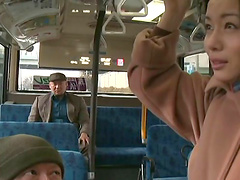 Japanese slut lets a man finger her pussy in a bus