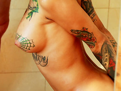 Tattooed brunette blows and gets banged in the shower