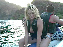 Fun loving Alison Angel rides a jetski topless on a lake