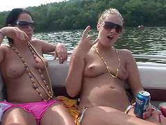 Sexy lesbians in bikini having outdoor fun on a boat