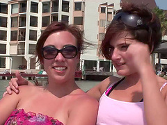 Two dark-haired hussies finger their pussies on a yacht