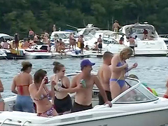 Bikini-clad babe with a great body flashing her big tits at beachgoers