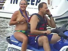 Bikini-clad babe with a great body flashing her big tits at beachgoers