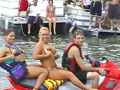 Bikini-clad babe with a great body flashing her big tits at beachgoers