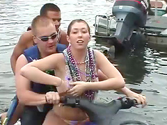 Bikini-clad babe with a great body flashing her big tits at beachgoers