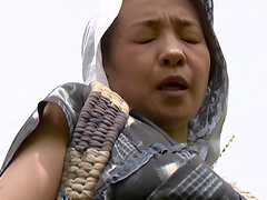 Mature Asian woman with big tits enjoying a hardcore fuck in a field