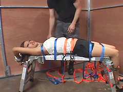 Gorgeous Asian submissive gets strapped to a bench by her Master