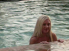 Blonde chick gets naked and goes swimming in the hotel pool