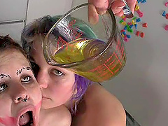 Chubby lesbian babes with nose piercings enjoying a hot piss drinking shoot