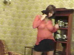 Randy brunette babe enjoys strips down in thong and miniskirt