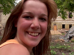 Girl in the dirt spreads her legs and fucks her purple dildo