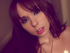 Ariel Rebel on her knees sucking a dildo and getting naked slowly