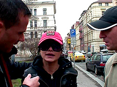 Babe in a leather corset Tera Joy on her knees sucking two cocks