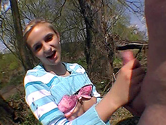 Czech teen fondling her natural tits while giving a handjob outdoors