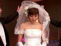 A Japanese bride wears her wedding gown while bouncing on a dick
