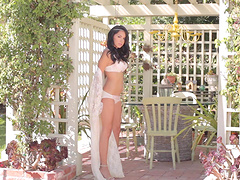 Brunette beauty with tight pussy lips poses nude outdoors