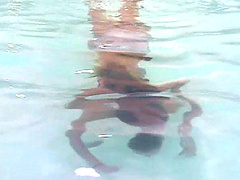 Bikini babe with wonderful titties swims in the pool