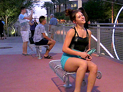 Pretty solo model in a sexy miniskirt pleasures herself while sitting in public