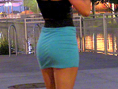 Pretty solo model in a sexy miniskirt pleasures herself while sitting in public