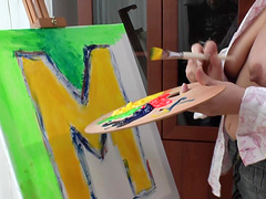 Naked mature hottie covers her body in colorful paint