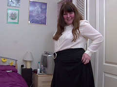 Stripping mature girl spreads her legs and toys her cunt