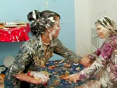 Ladies throw pies on each others faces and make a mess