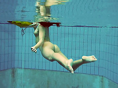 Alla Birtakik jumps in the pool and drops her white bikini