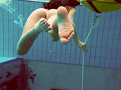 Alla Birtakik jumps in the pool and drops her white bikini