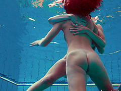Redhead European lesbian teen getting cozy underwater