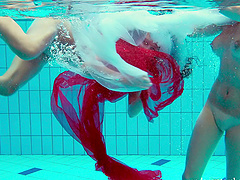 Redhead European lesbian teen getting cozy underwater