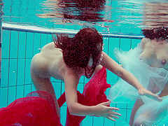 Redhead European lesbian teen getting cozy underwater