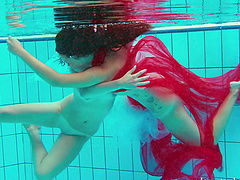 Redhead European lesbian teen getting cozy underwater