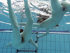 Nice ass lesbian with natural boobs performing her teases underwater