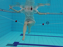 Tattooed small tits brunette babe showcasing her boobs at the pool