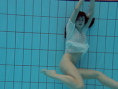 Tattooed small tits brunette babe showcasing her boobs at the pool