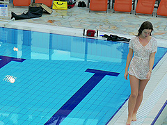 Tattooed small tits brunette babe showcasing her boobs at the pool