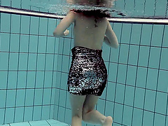 Sensual brunette babe Loris Licicia jumps in the pool and strips