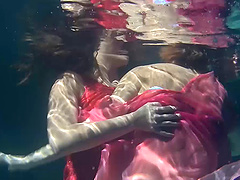 Cute European lesbian with small tits getting cozy with her babe in pool