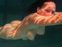 European brunette showcasing her shaved pussy in the pool