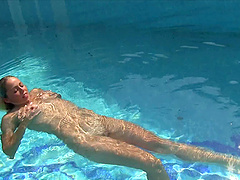 Teen Christen loves swimming naked and teasing with her pussy