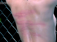 Gorgeous brunette girl gets tied up to the fence by two friends