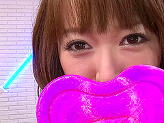 Japanese teen fetish model plays with a lollipop and her tits